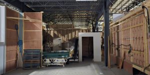 An image of our warehouse area with hospital bed and other stored props.